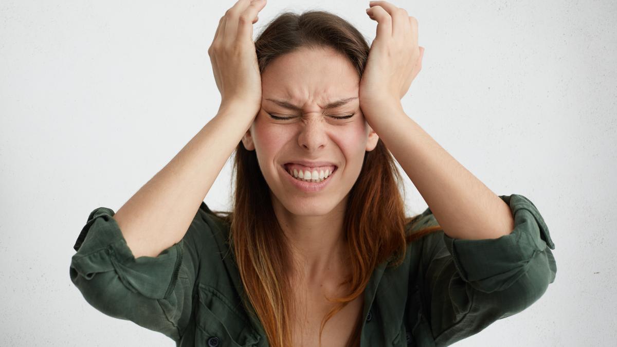 disappointed_woman_holding_her_hands_temples_frowning_face_woman_regretting_her_act_female_despair_shock