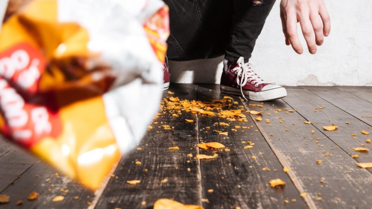angry-young-man-throwing-packet-potato-chips-camera