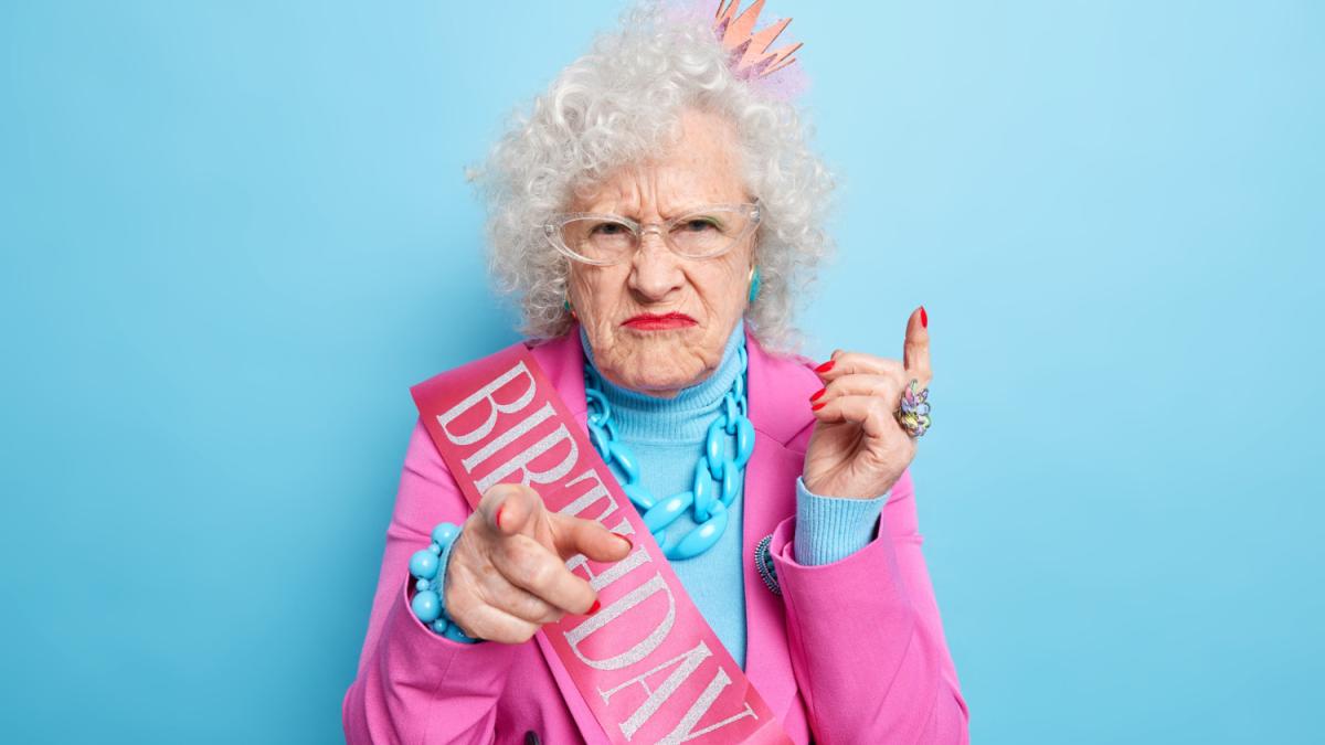 disappointed-mature-woman-squints-face-points-directly-you-invites-her-birthday-party-dressed-festive-clothes-being-angry-with-offensive-words-about-her-age-wears-bright-makeup-stands-indoor