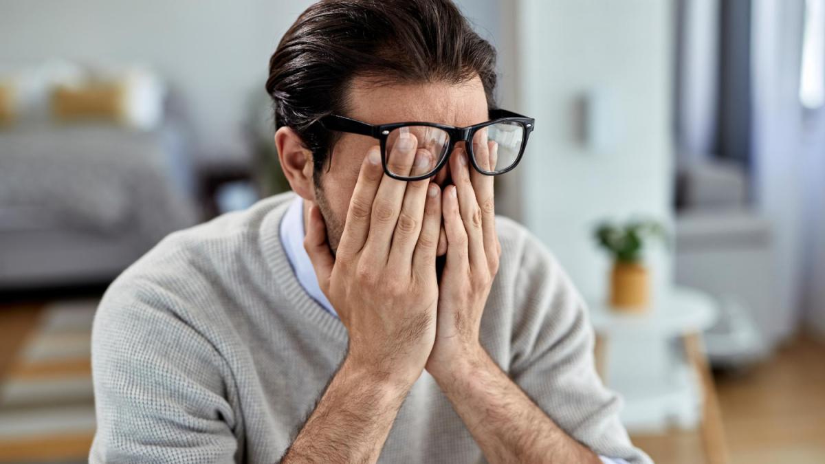 young-businessman-feeling-exhausted-while-working-home-png_98674000