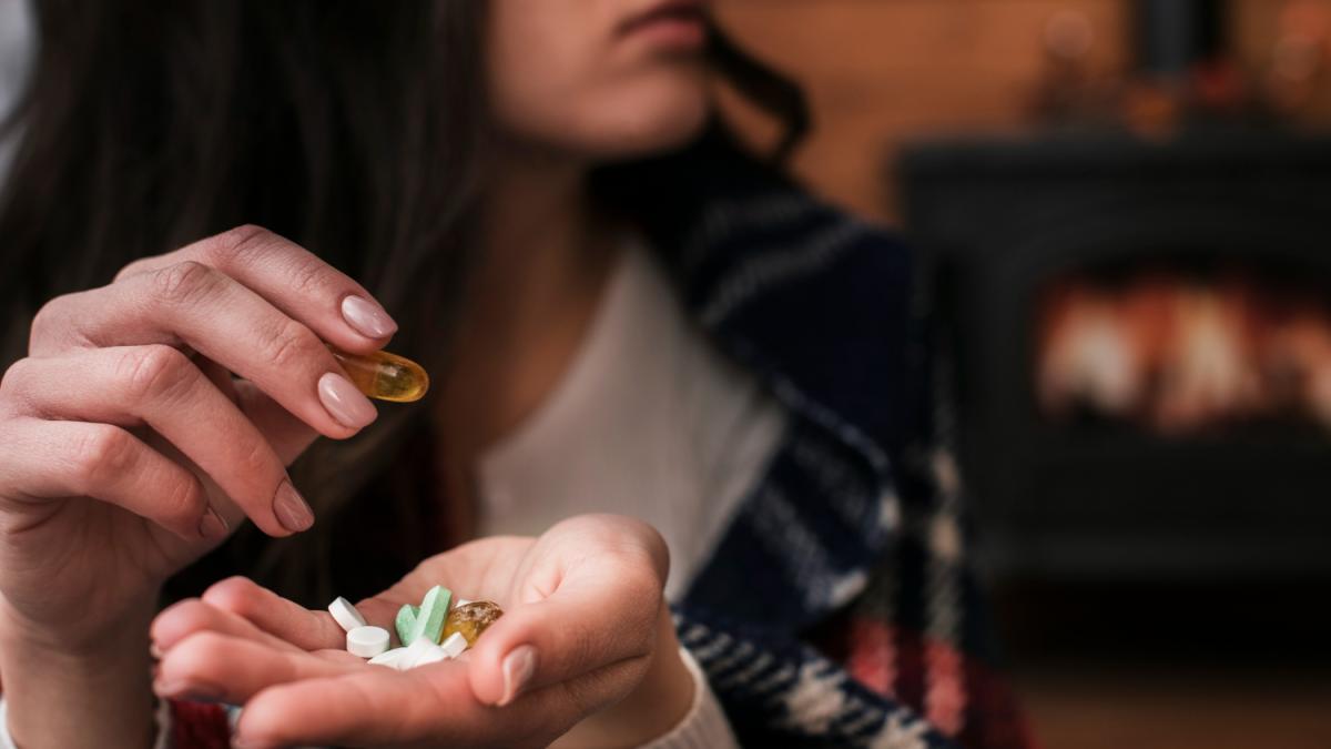 close-up-woman-holding-medicine-her-hand_39662500