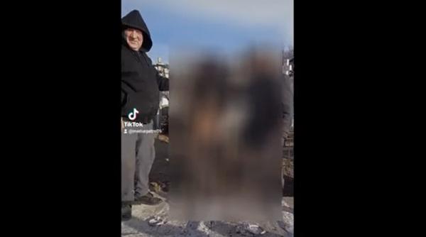 Dosar penal, după ce doi români s-au filmat când dansează pe manele şi ţin în mâini scheletul unui femei proaspăt deshumate