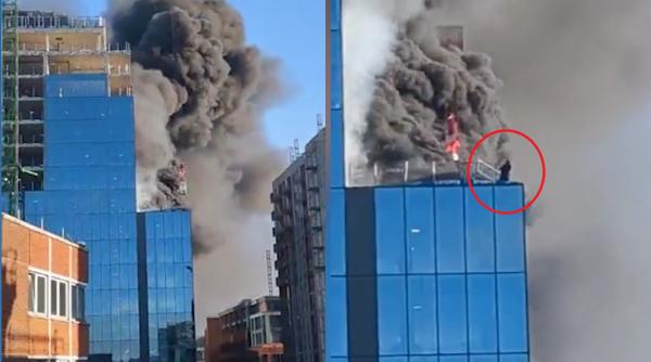 Imagini dramatice în Anglia: Un bărbat e salvat în ultima clipă de pe acoperișul unei clădiri cuprinse de flăcări - VIDEO